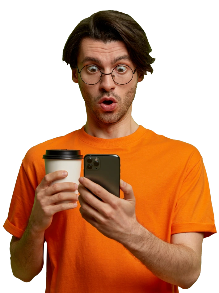 AEY About Us-A surprised man in an orange shirt holding a coffee cup and checking his phone with wide eyes